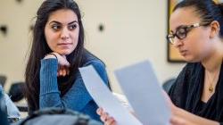 Photo of students comparing notes in class.