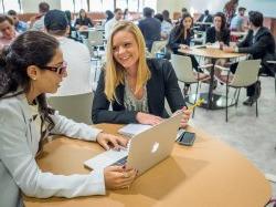 Students speaking at a table