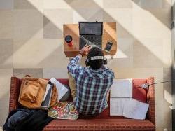 A student sitting in CELS studying on their laptop.