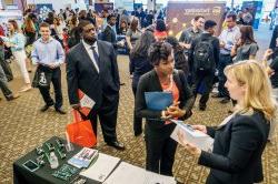 Students networking with employers at the career fair.