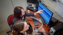 Elaine Hitchcock with student reviewing results on computer monitor