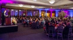 2014 Foundation Annual Scholarship Dinner. Tables and chairs set up at a night time eent with multi-colored lighting all around. One of the many setups available for the Conference Center's Main Ballroom.