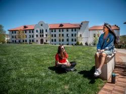 Two students sitting outside Russ hall