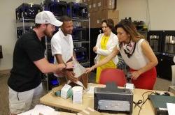 Two women look at innovation items made by two male students