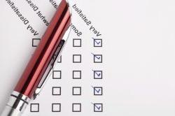 Stock photo of a satisfaction survey with checkboxes and a pen