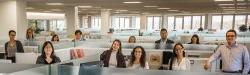 University Communications team standing in cubicles