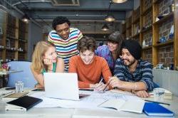 A diverse group of students brainstorming together.