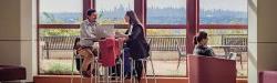 two students studying with NYC skyline in background