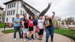 Seven people pose for “a selfie.”