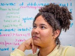 Student listens in classroom.