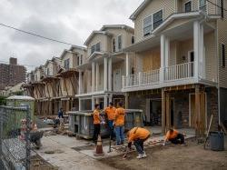 Montclair State University volunteers work together on a Habitat for Humanity home construction site in Paterson, NJ, as part of the 9/11 Day of Service and Remembrance.