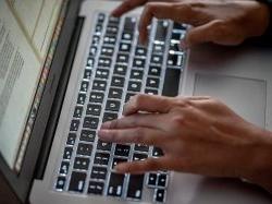 hands typing on laptop