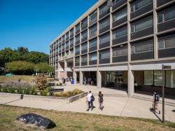 The outside of Blanton Hall on a sunny day with students walking around.