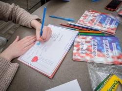 Students writing cards on a service day.