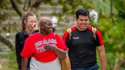 Three students walking and laughing